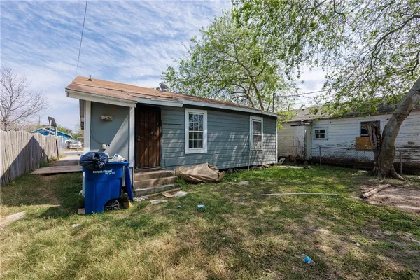 a backyard of a house with barbeque oven and outdoor seating