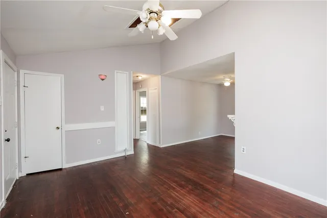a view of an empty room with wooden floor