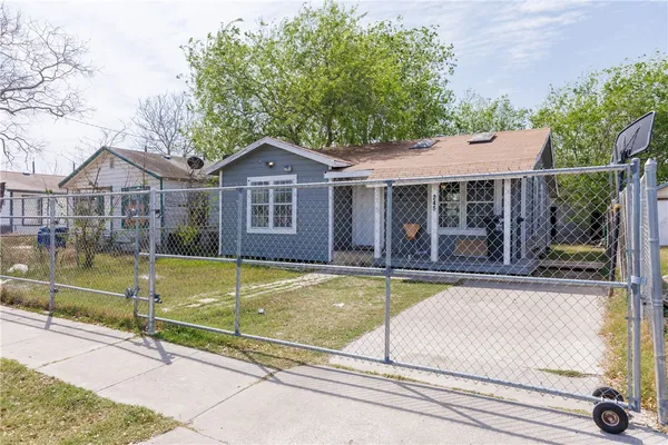 a view of a house with pool plants and large trees