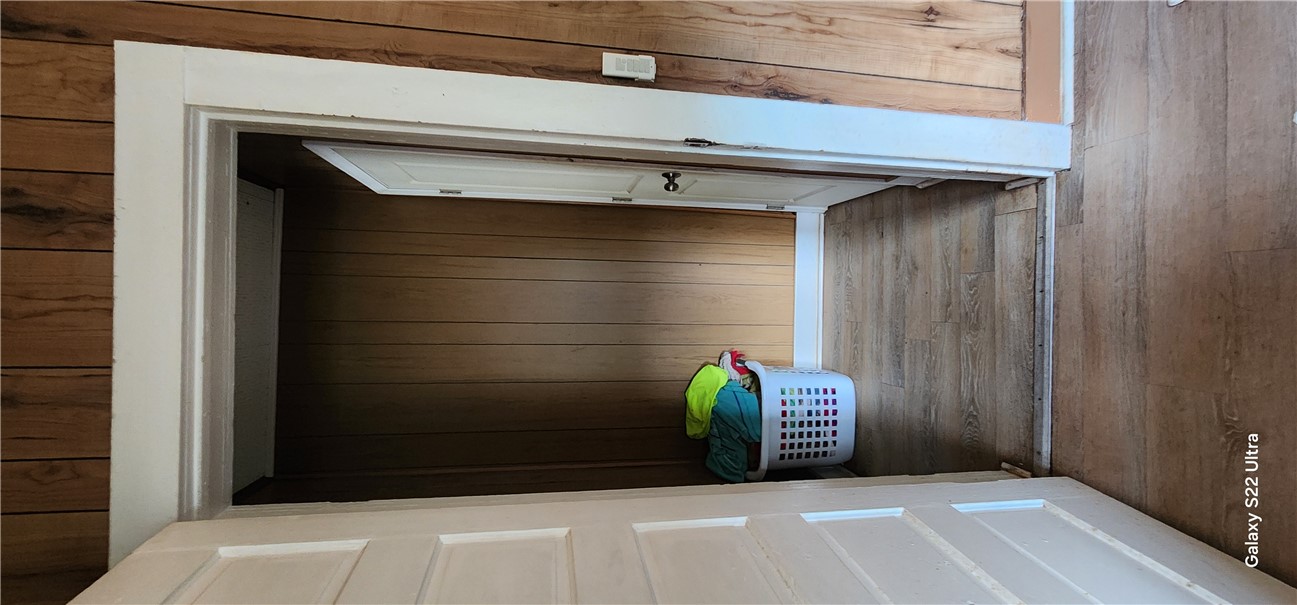 105 Hope Avenue Seneca, SC 29678 - Photo 15 of 33 A compact laundry space features practical wood paneling and durable vinyl flooring.