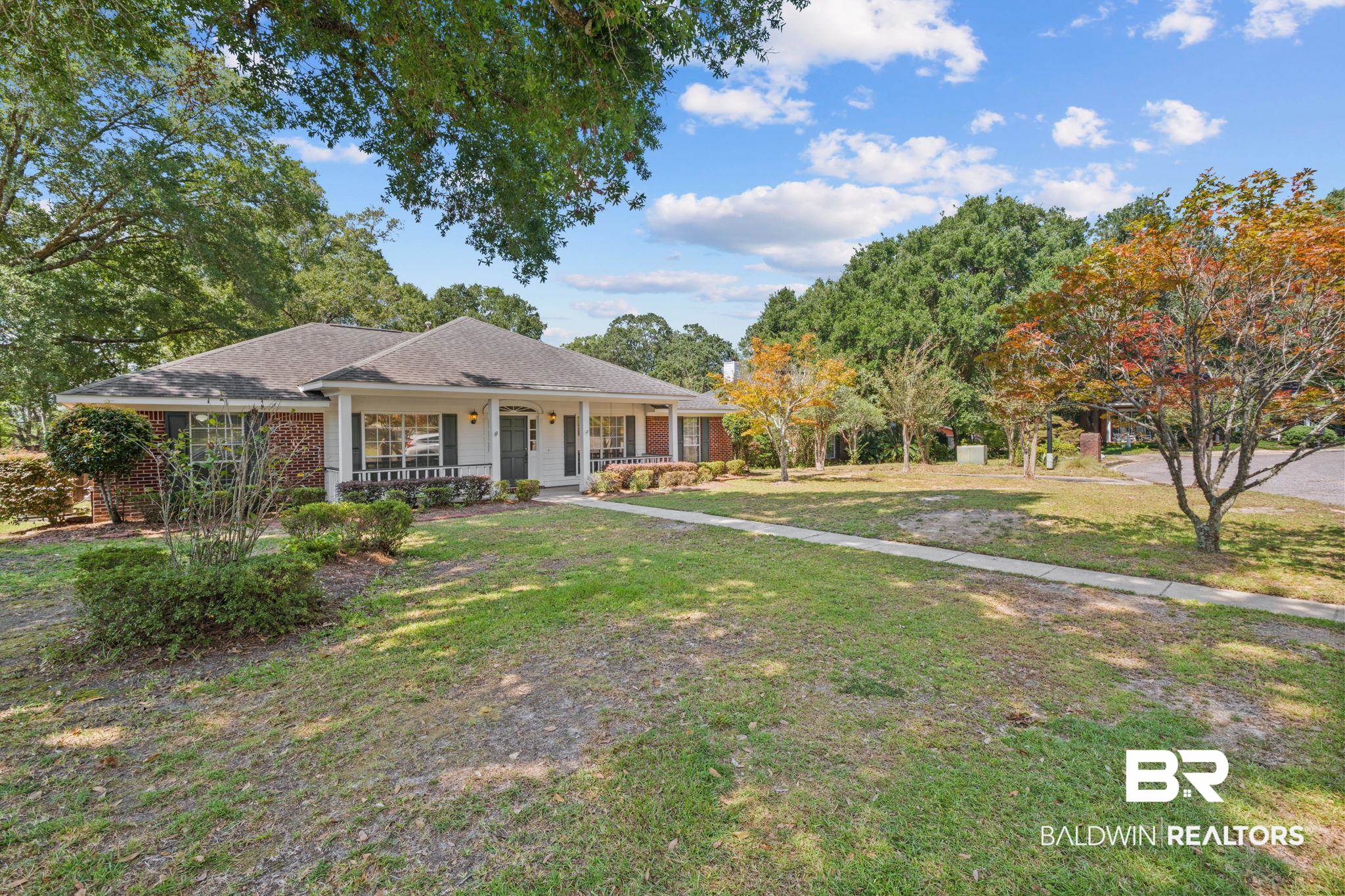 1340 Wellsley Court Mobile, AL 36695 - Photo 1 of 37 Ranch-style home featuring a porch, brick siding, a front lawn, and a shingled roof