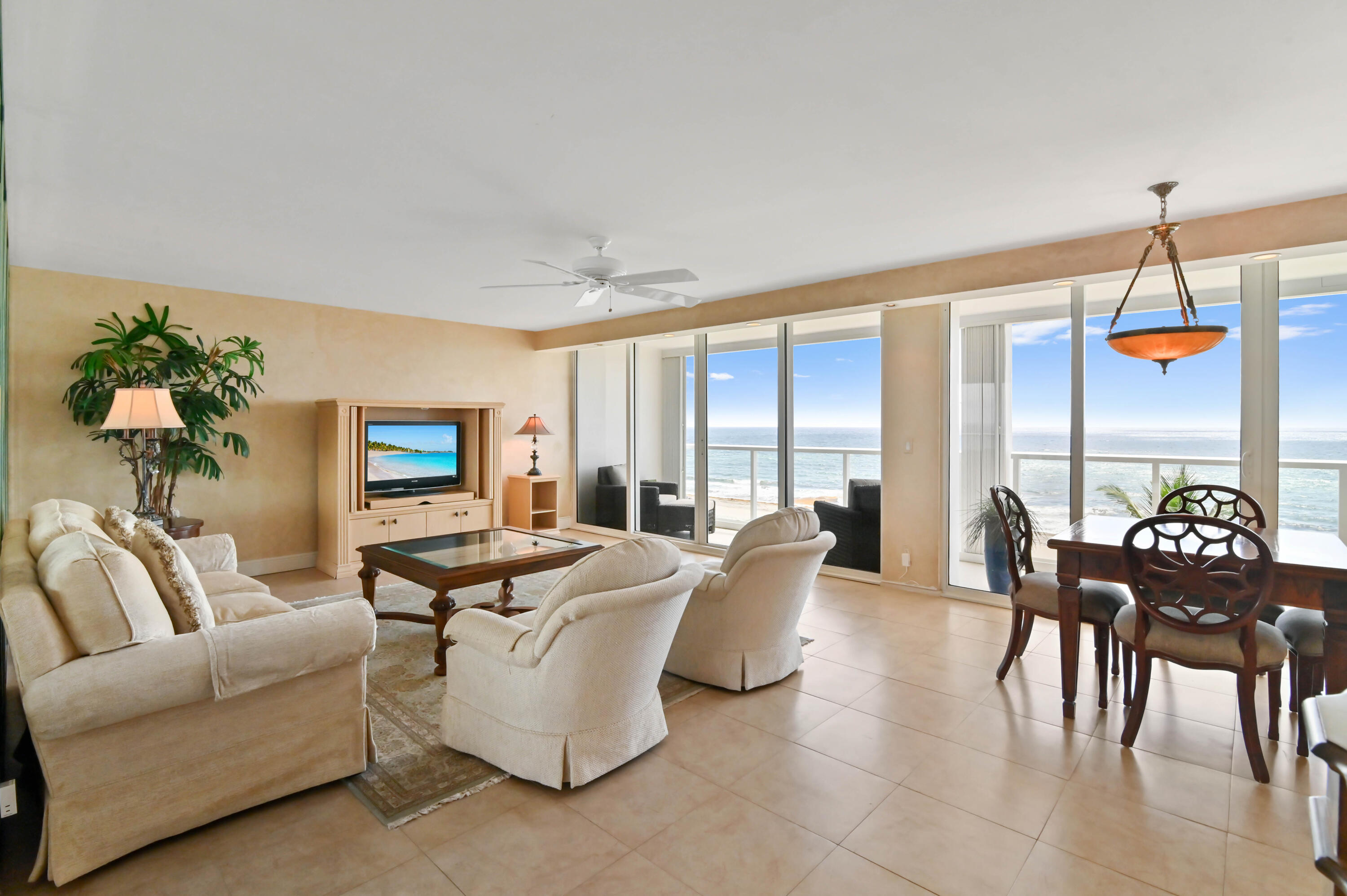 2800 South Ocean Boulevard, Unit 5J Boca Raton, FL 33432 - Photo 4 of 56 a living room with furniture a dining table and a potted plant