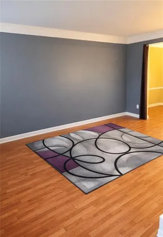 a view of a room with wooden floor