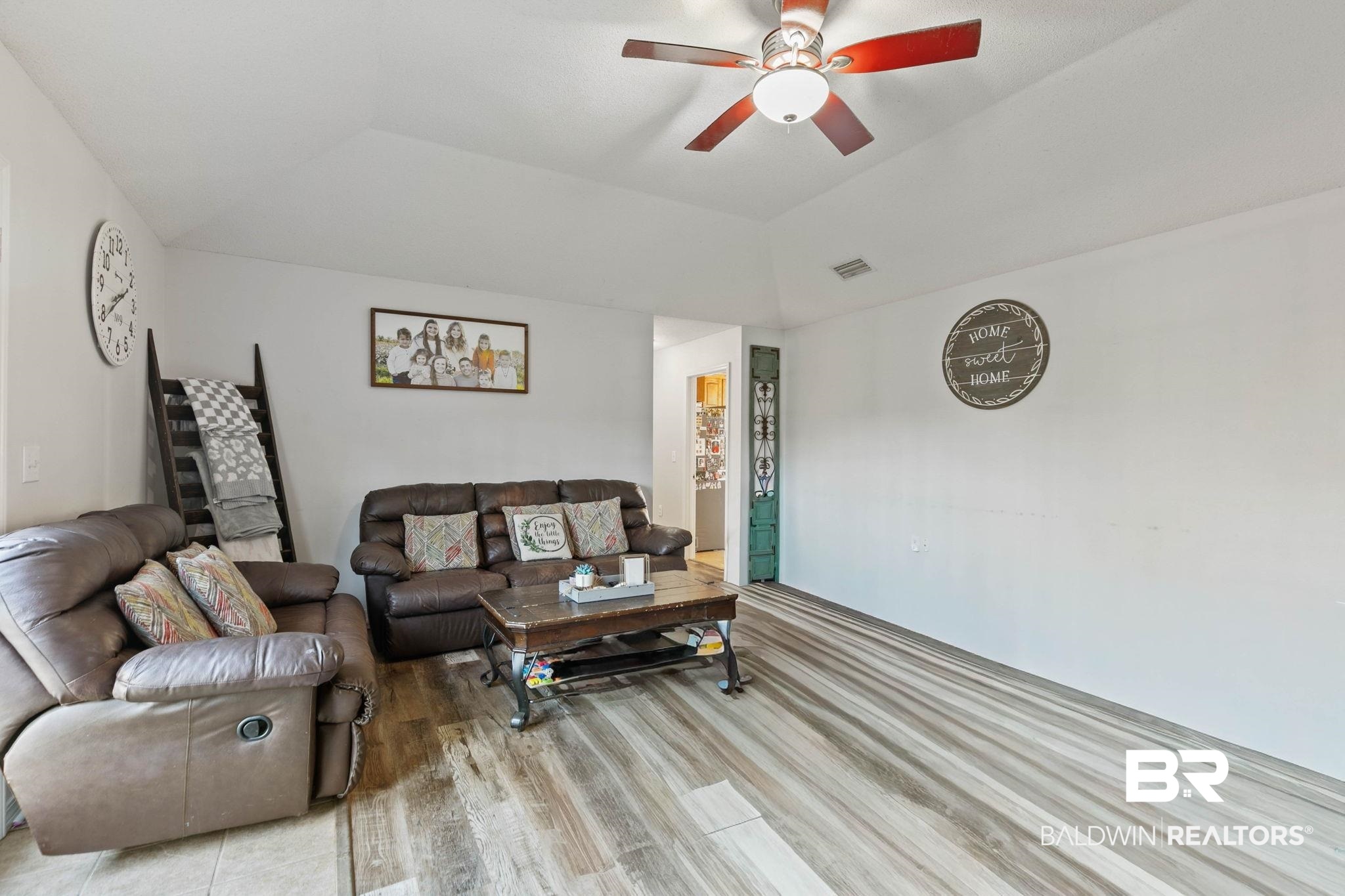 55750 Lottie Road Perdido, AL 36562 - Photo 69 of 84 Living area featuring wood finished floors, ceiling fan, and vaulted ceiling