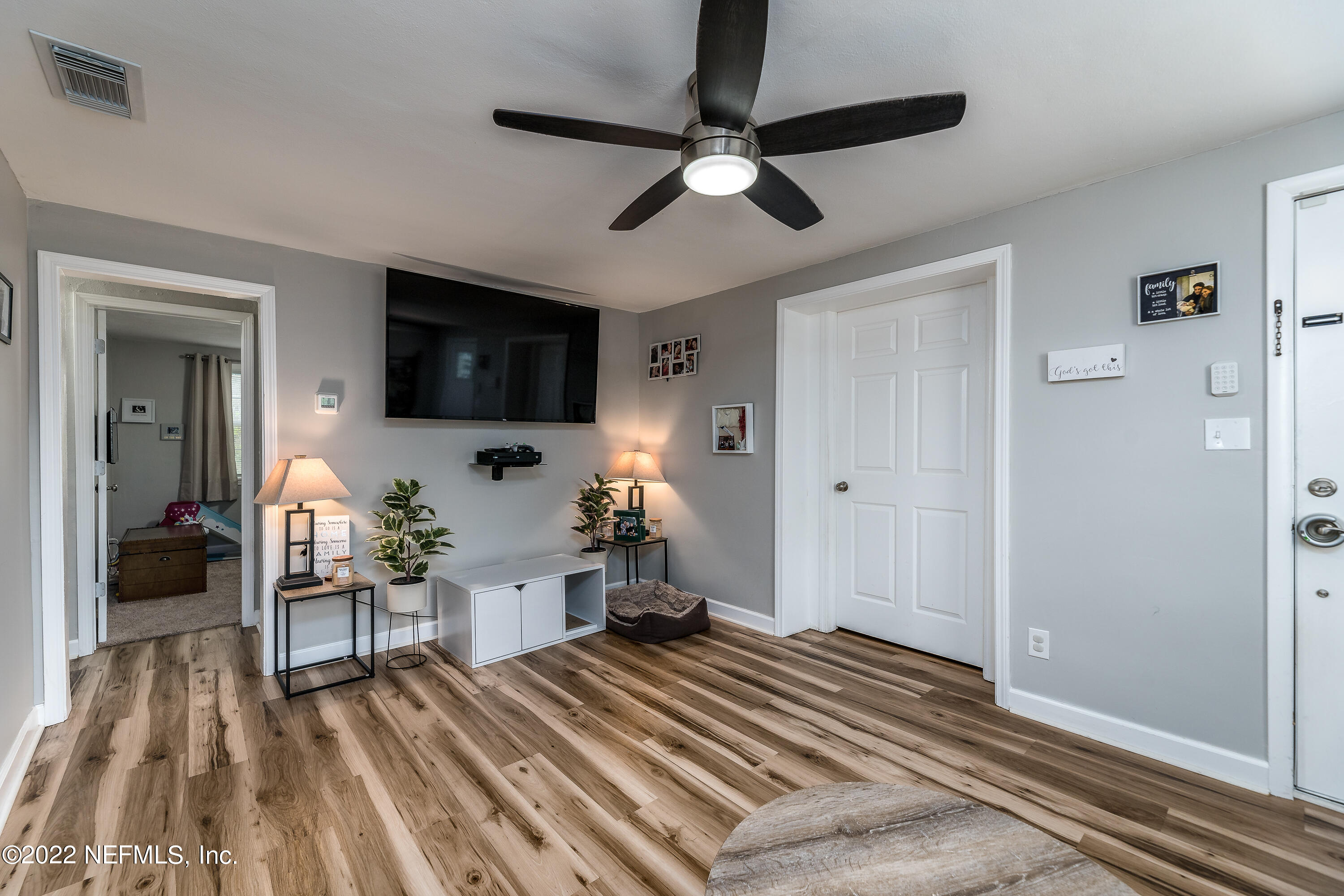 5807 Ricker Road Jacksonville, FL 32244 - Photo 11 of 31 a living room with furniture and a flat screen tv