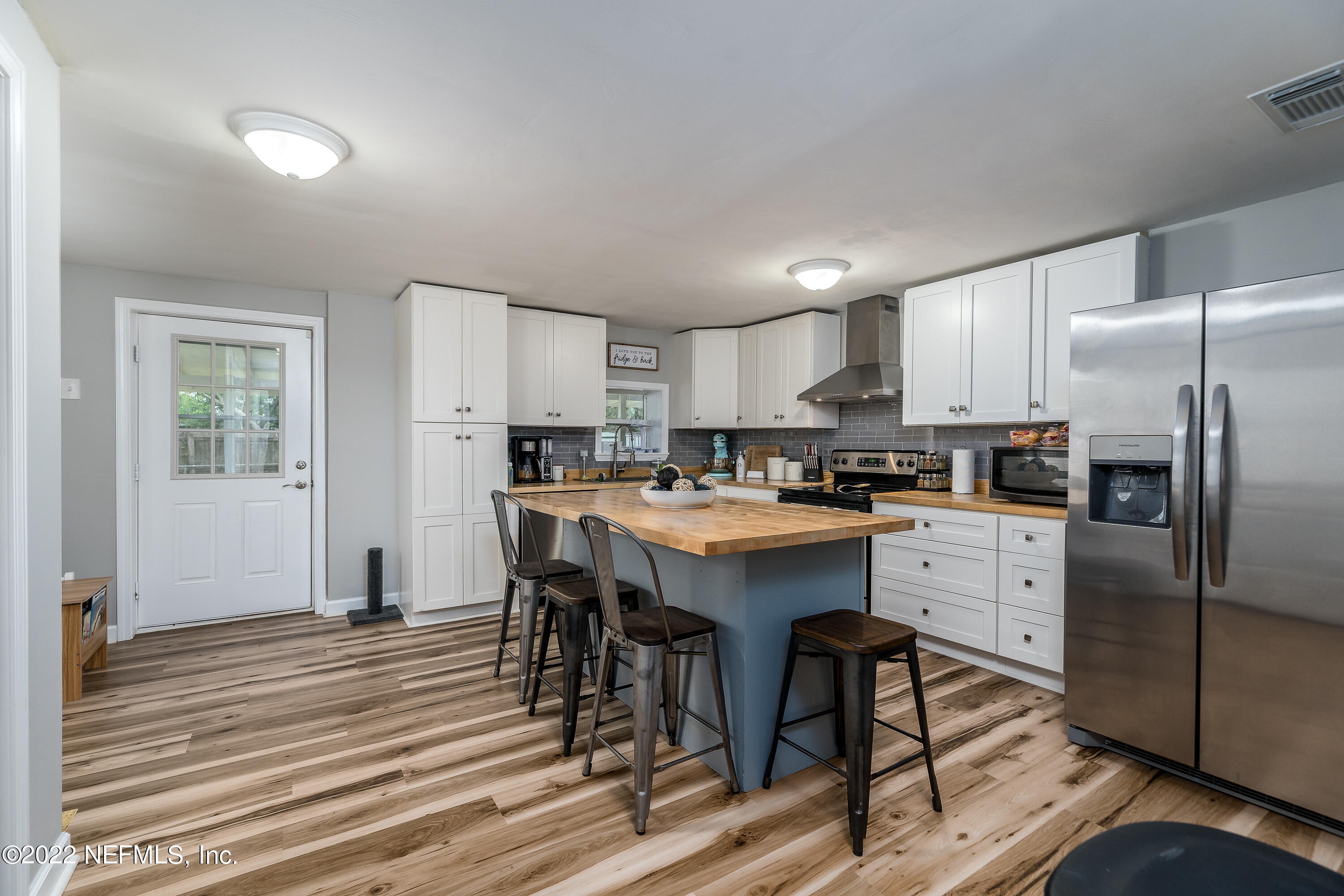 5807 Ricker Road Jacksonville, FL 32244 - Photo 12 of 31 a kitchen with a refrigerator a sink and cabinets