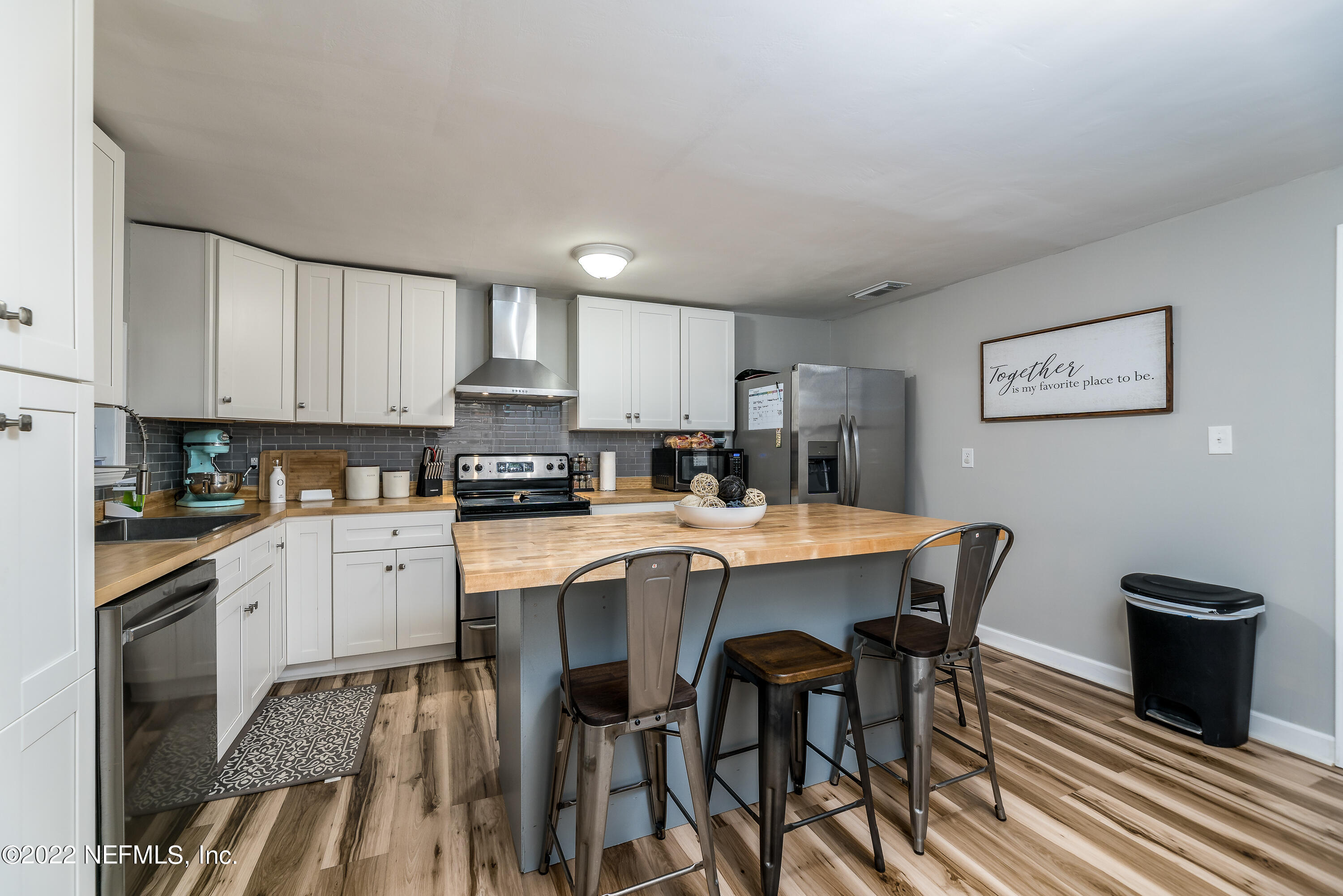5807 Ricker Road Jacksonville, FL 32244 - Photo 13 of 31 a kitchen with stainless steel appliances granite countertop a stove a sink a microwave and a refrigerator