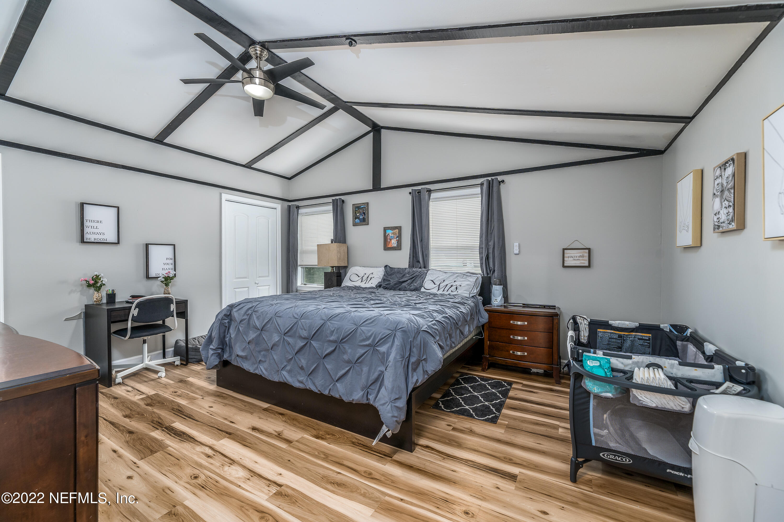 5807 Ricker Road Jacksonville, FL 32244 - Photo 17 of 31 a bedroom with a bed a chair and the dresser