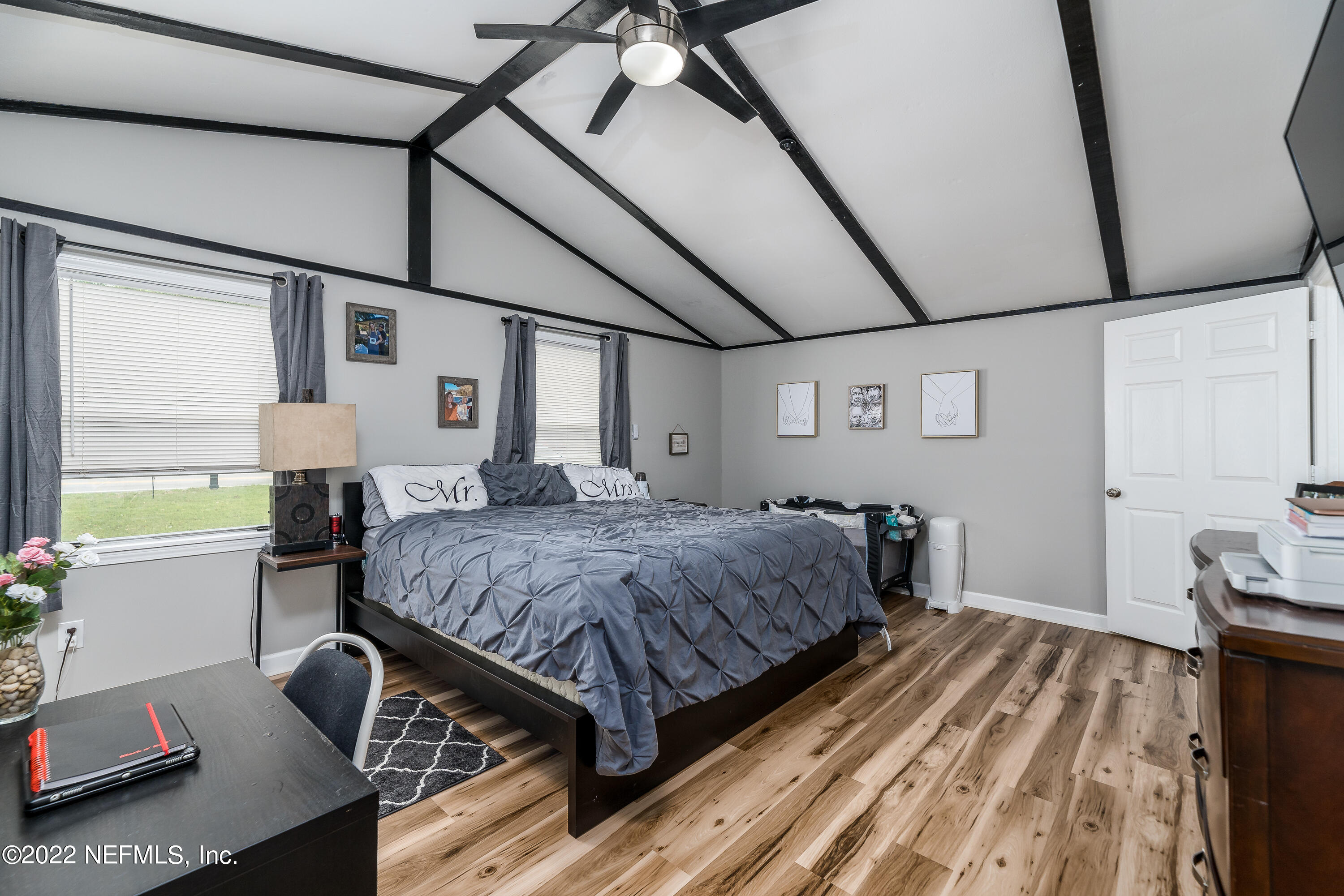 5807 Ricker Road Jacksonville, FL 32244 - Photo 18 of 31 a bedroom with a bed and wooden floor