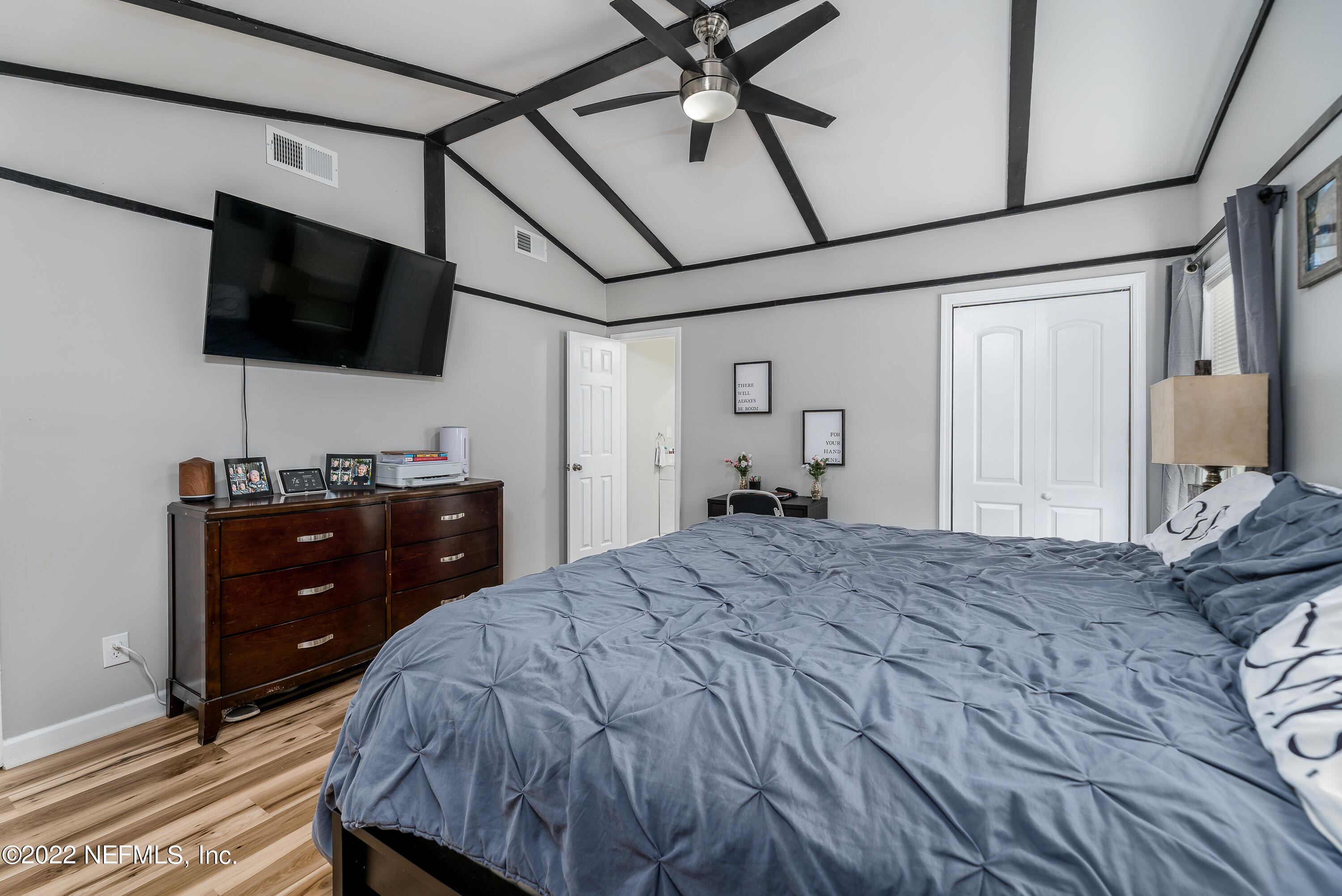 5807 Ricker Road Jacksonville, FL 32244 - Photo 19 of 31 a bedroom with a bed and a flat screen tv