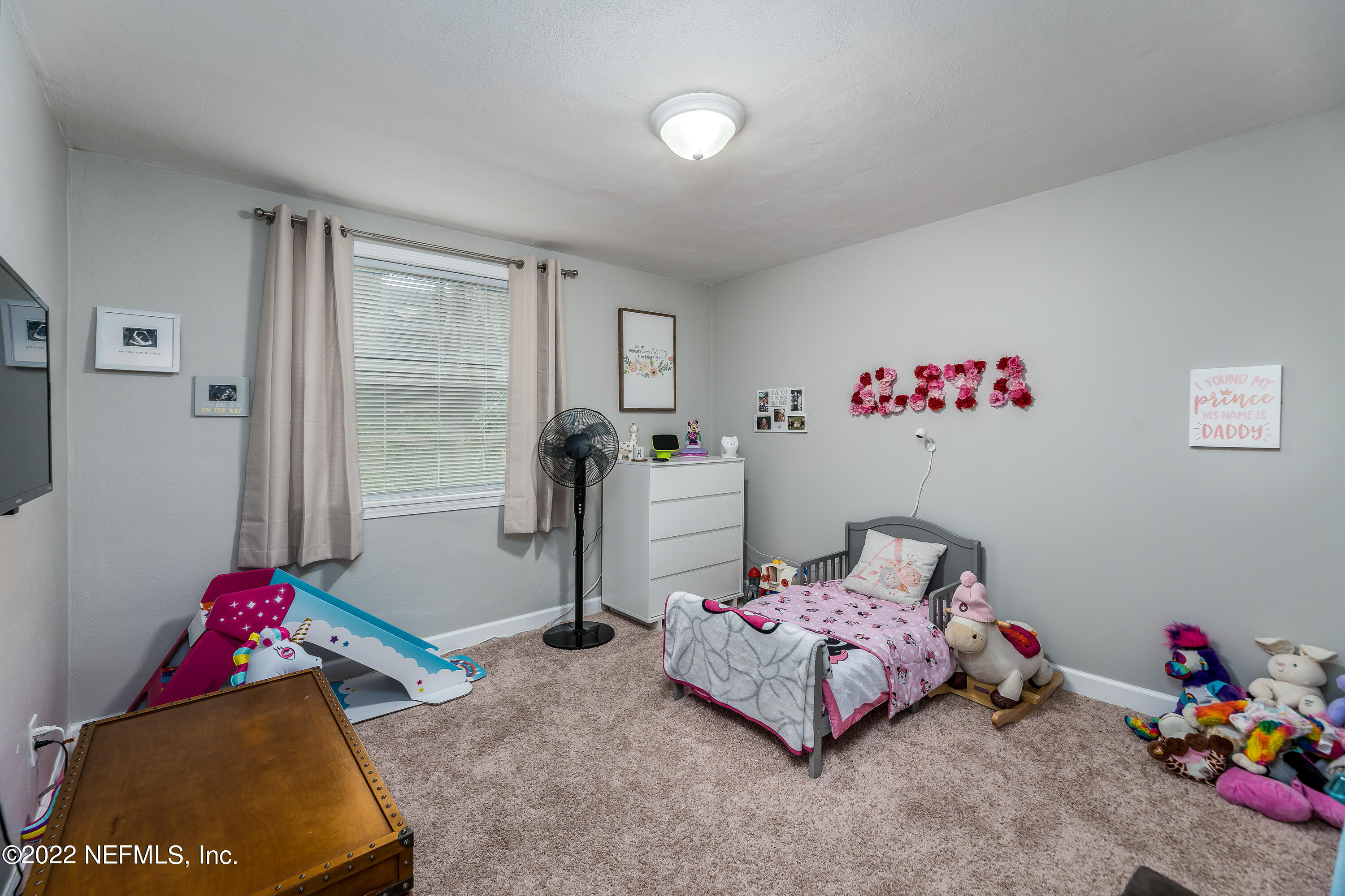 5807 Ricker Road Jacksonville, FL 32244 - Photo 21 of 31 a bedroom with furniture and a potted plant