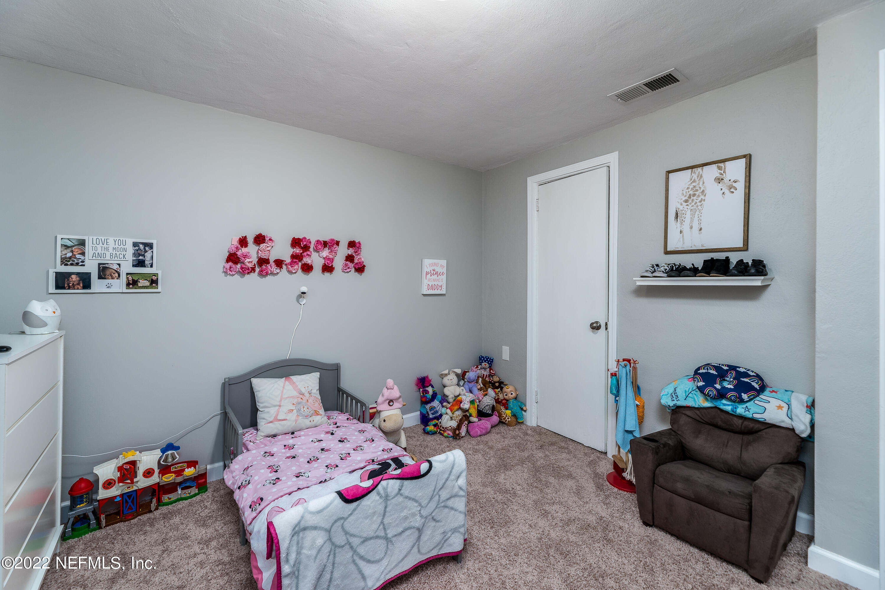 5807 Ricker Road Jacksonville, FL 32244 - Photo 22 of 31 a bedroom with furniture and a bed