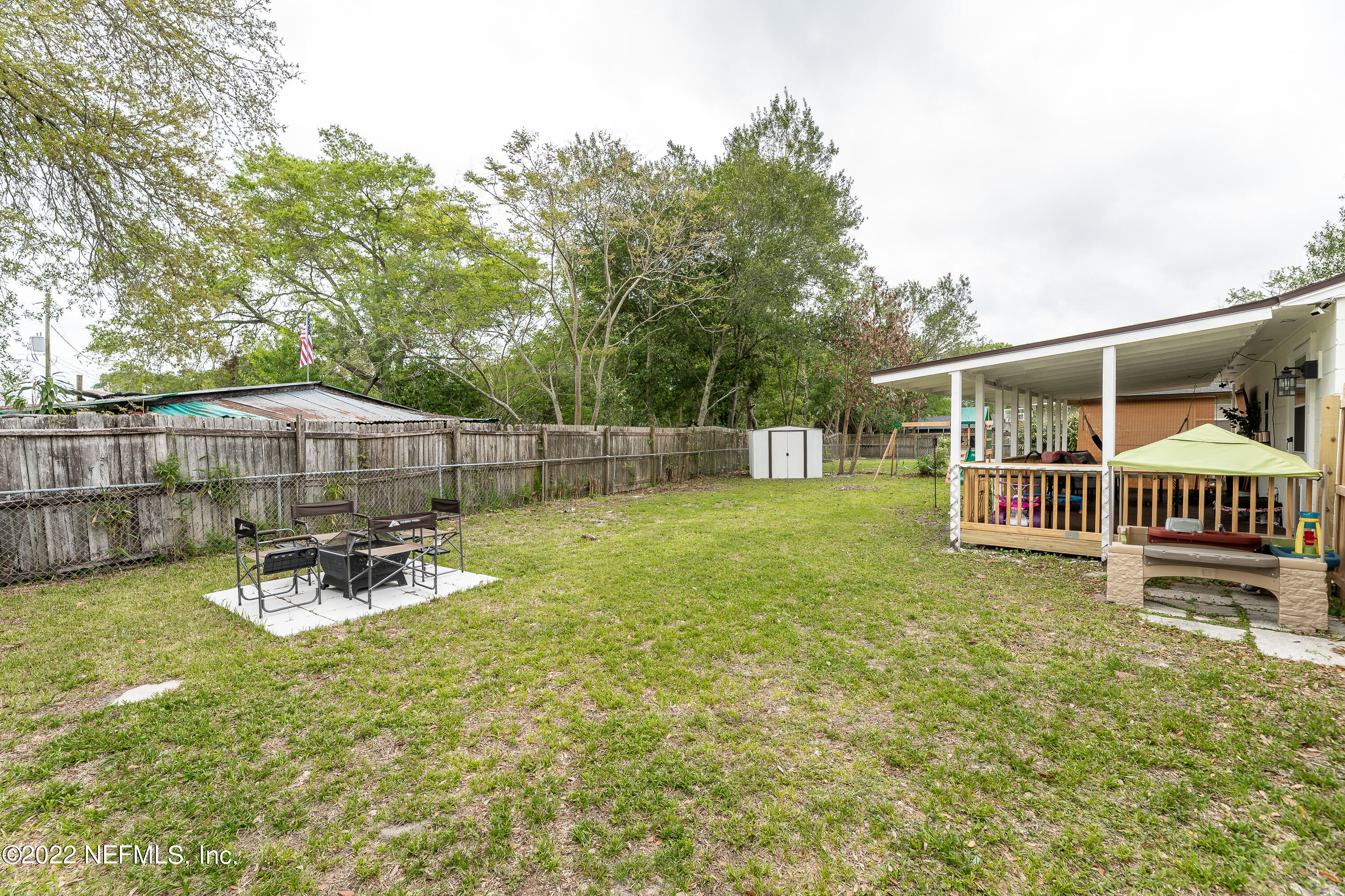 5807 Ricker Road Jacksonville, FL 32244 - Photo 28 of 31 a view of a patio with a table and chairs