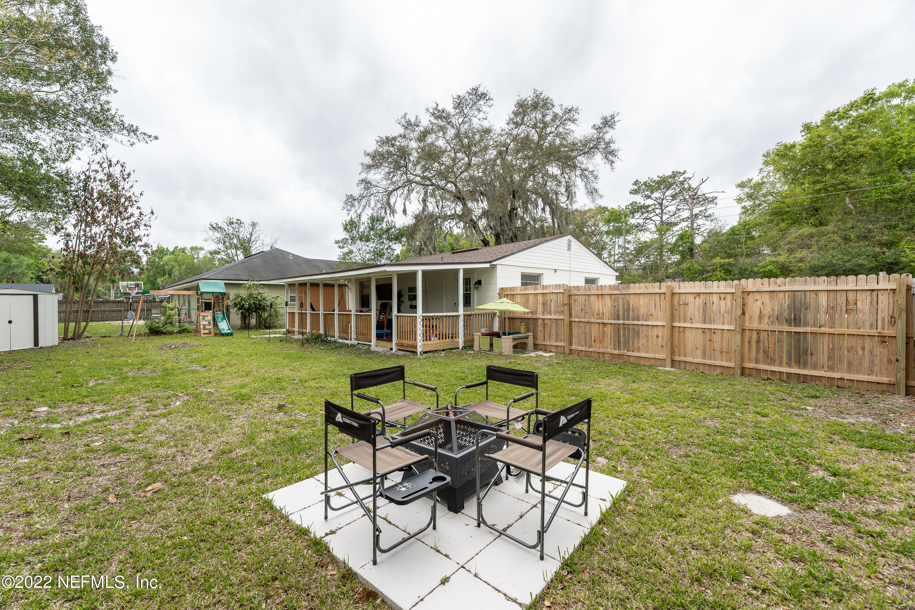 5807 Ricker Road Jacksonville, FL 32244 - Photo 29 of 31 a view of a house with backyard sitting area and garden