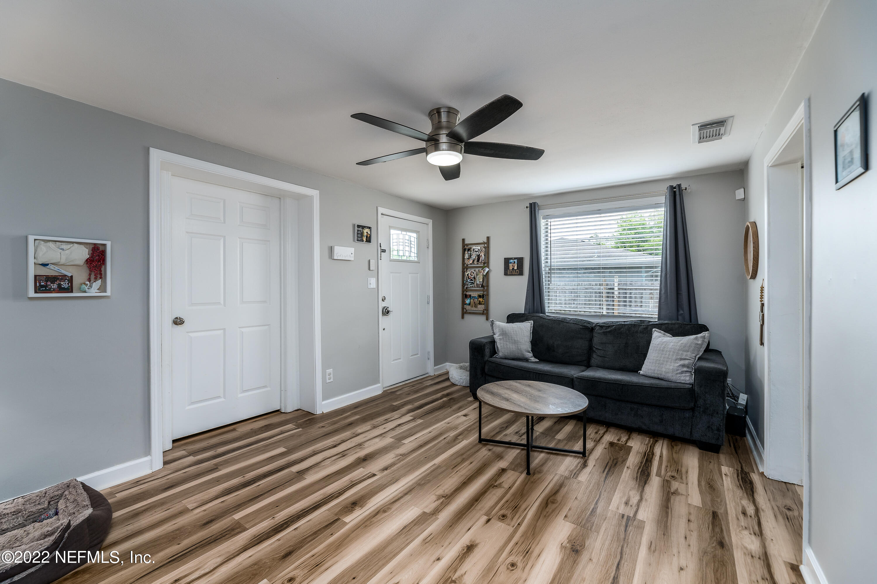 5807 Ricker Road Jacksonville, FL 32244 - Photo 10 of 31 a living room with a couch and a window