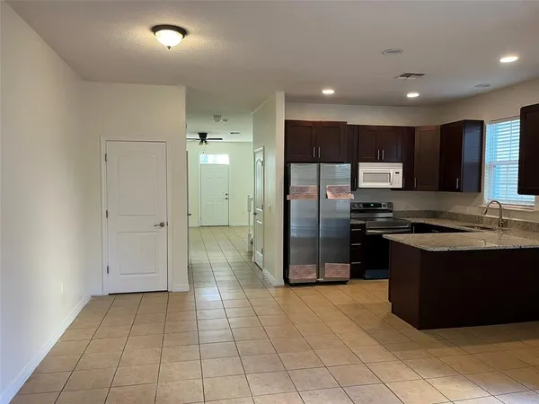 a kitchen with stainless steel appliances granite countertop a refrigerator and a sink