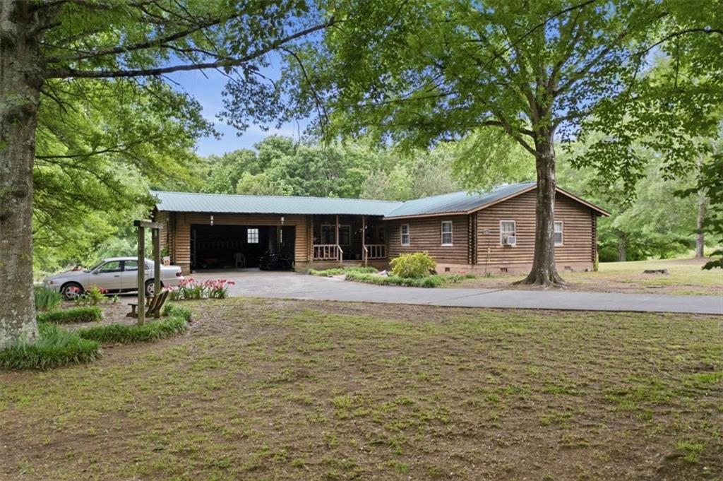 a front view of a house with a garden and porch