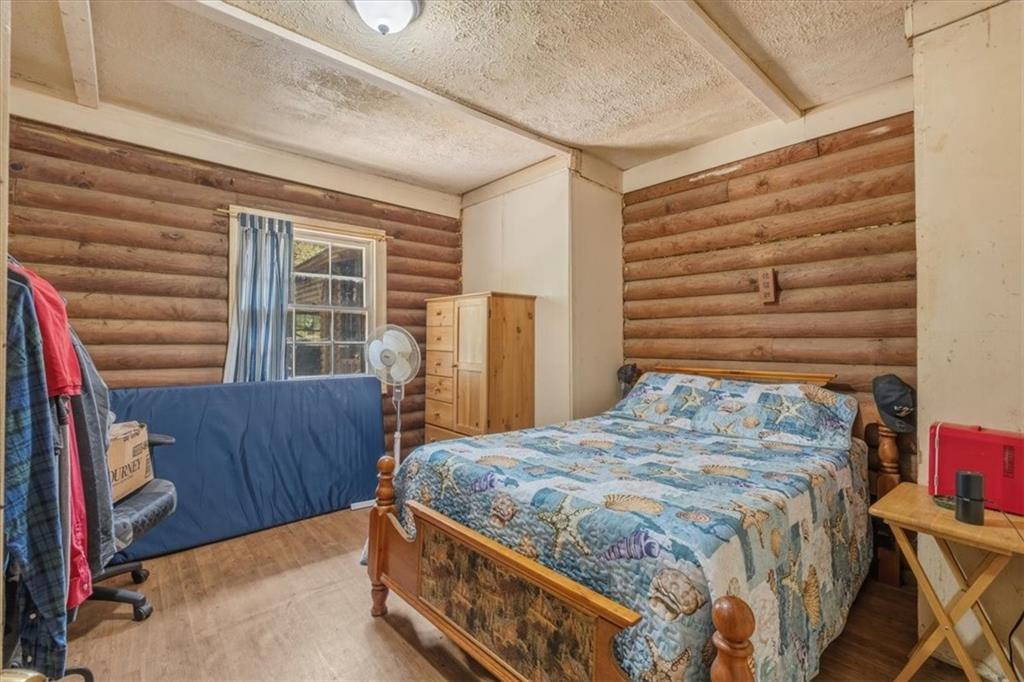266 Anderson Road Rockmart, GA 30153 - Photo 17 of 31 a bedroom with a bed and wooden floor
