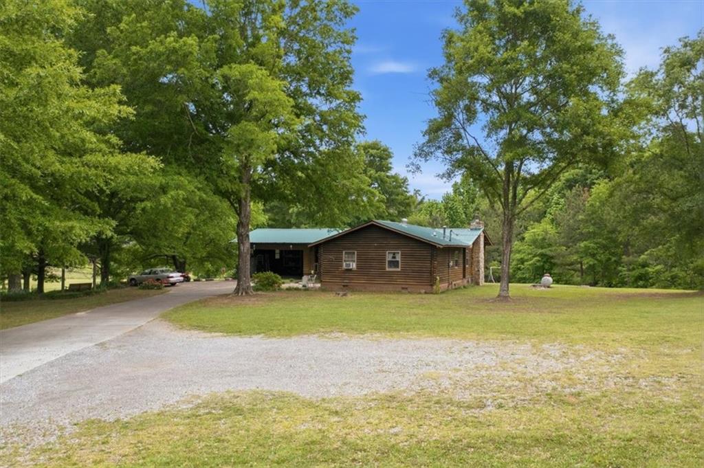 266 Anderson Road Rockmart, GA 30153 - Photo 2 of 31 a view of a house with a yard and large trees