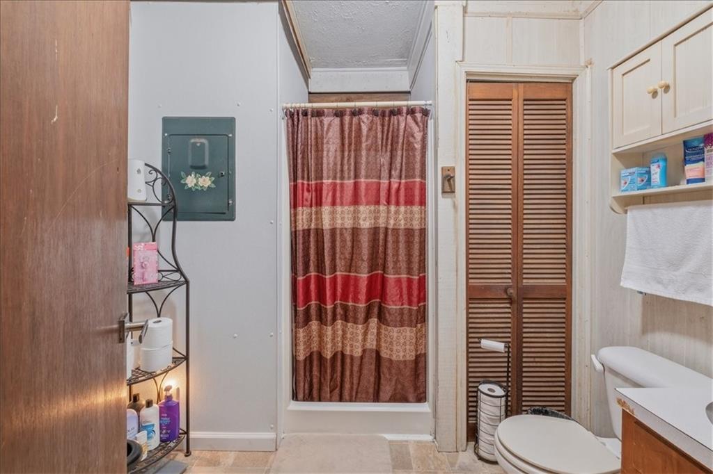 266 Anderson Road Rockmart, GA 30153 - Photo 22 of 31 a bathroom with a toilet and shower curtain