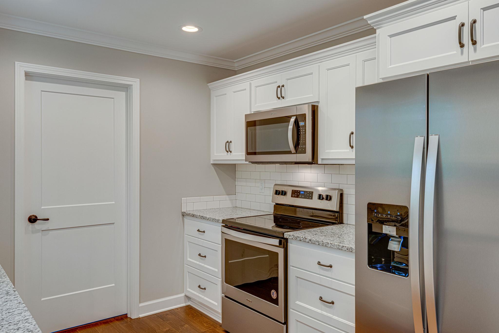 975 Hargrove Road West Dickson, TN 37055 - Photo 7 of 19 a kitchen with stainless steel appliances white cabinets and a stove