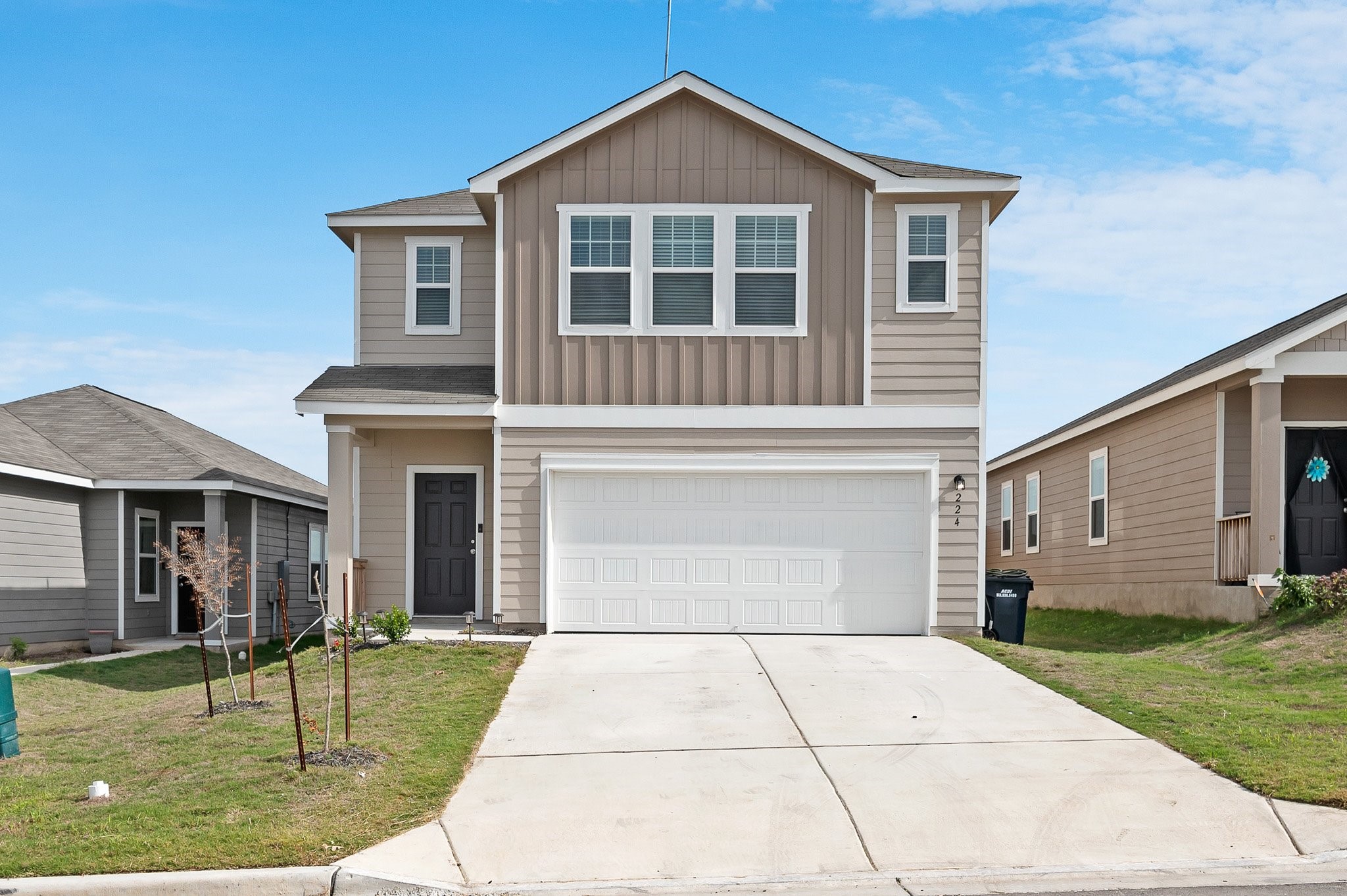 a front view of a house with a garden and plants