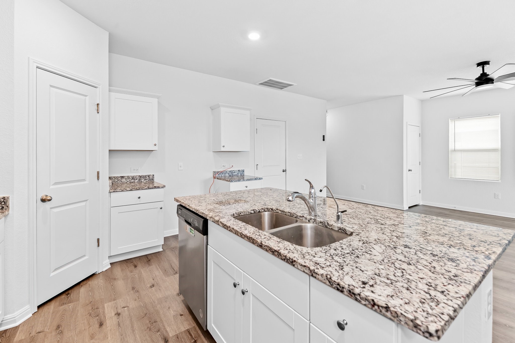 224 Night Riders Way Jarrell, TX 76537 - Photo 16 of 40 a kitchen with white cabinets a sink and dishwasher