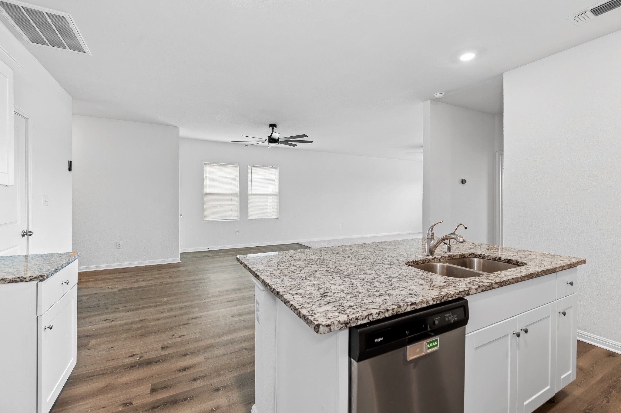 224 Night Riders Way Jarrell, TX 76537 - Photo 18 of 40 a kitchen with granite countertop granite countertop a sink and a wooden floor