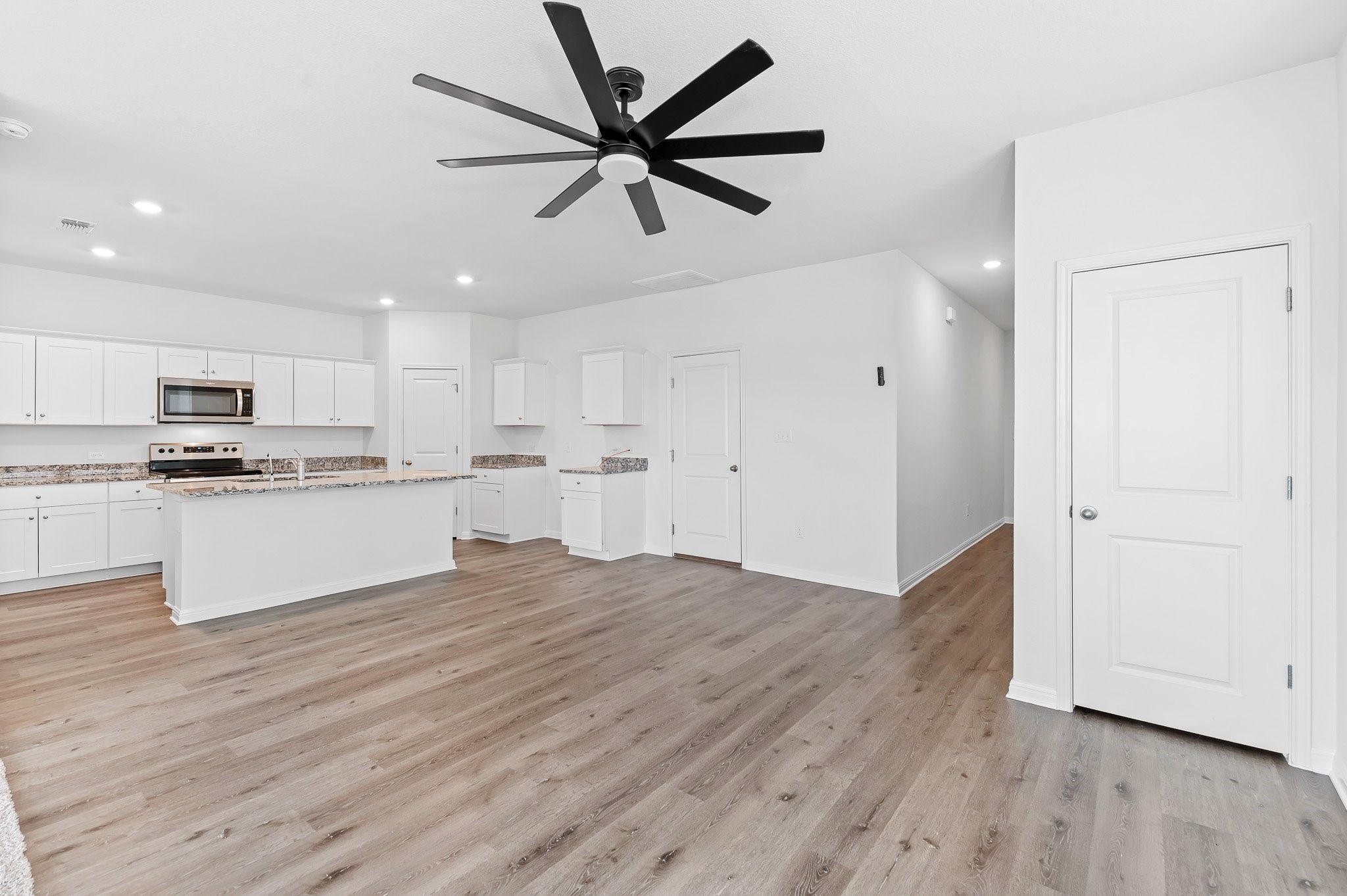 224 Night Riders Way Jarrell, TX 76537 - Photo 20 of 40 a view of kitchen with cabinets wooden floor and stainless steel appliances