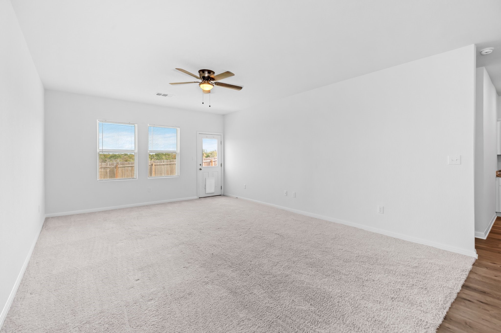 224 Night Riders Way Jarrell, TX 76537 - Photo 23 of 40 an empty room with windows and ceiling fan view