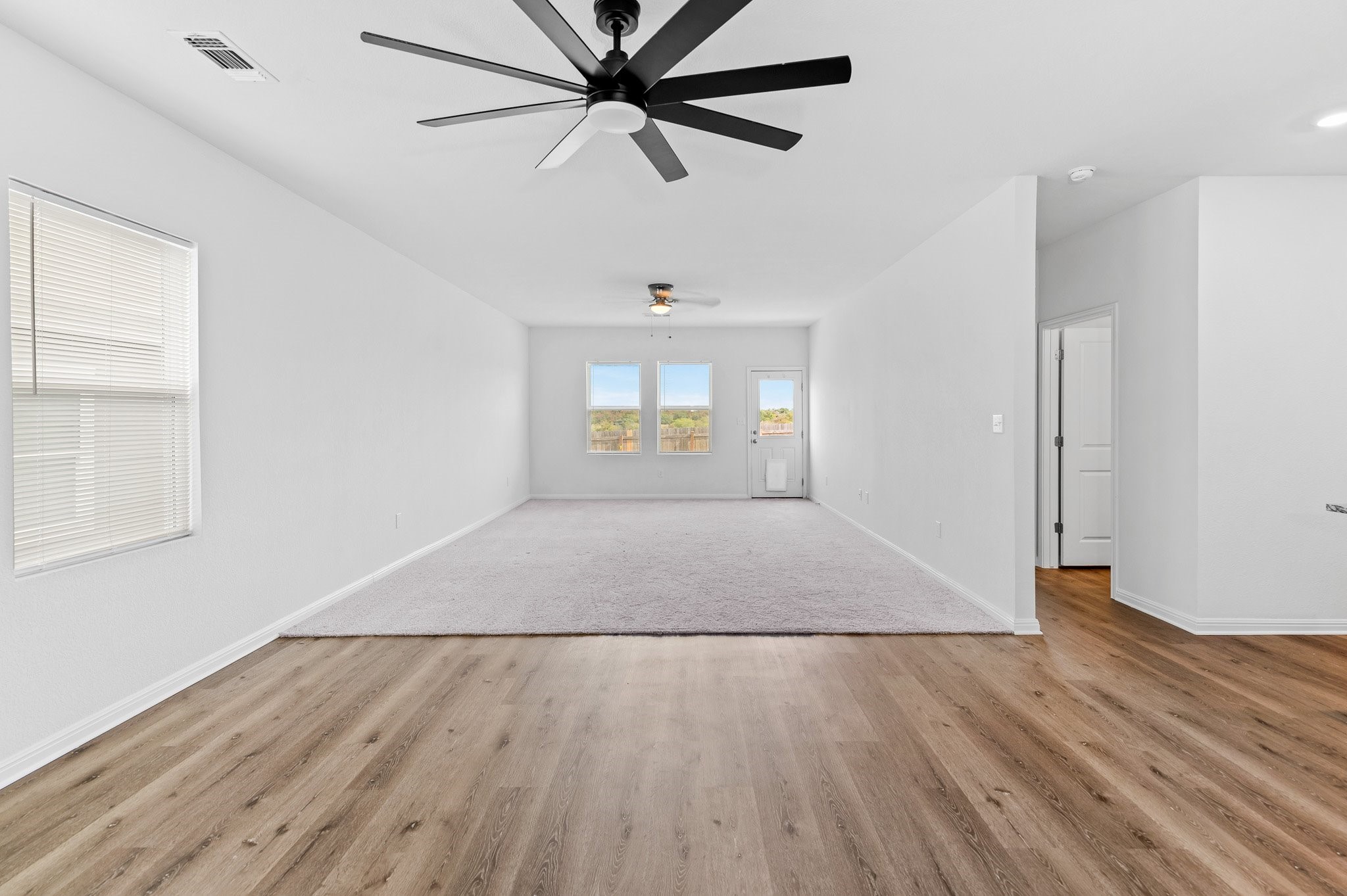224 Night Riders Way Jarrell, TX 76537 - Photo 7 of 40 wooden floor in an empty room with a window