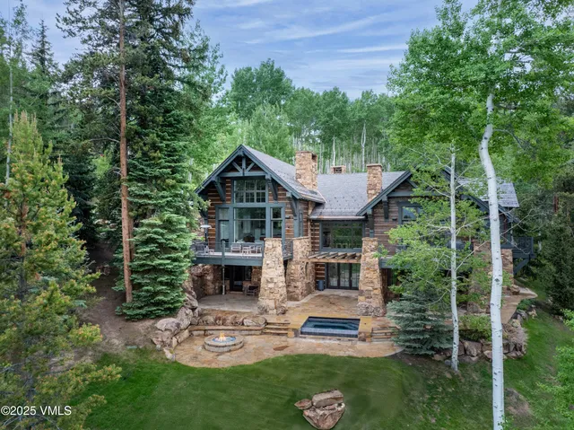 a dining room with stainless steel appliances kitchen island granite countertop a table chairs and a view of living room