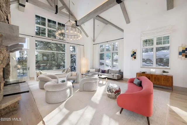 a bedroom with a large bed a flat screen tv and a couch