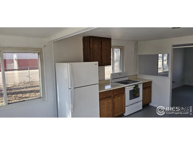 a kitchen with a refrigerator and a stove