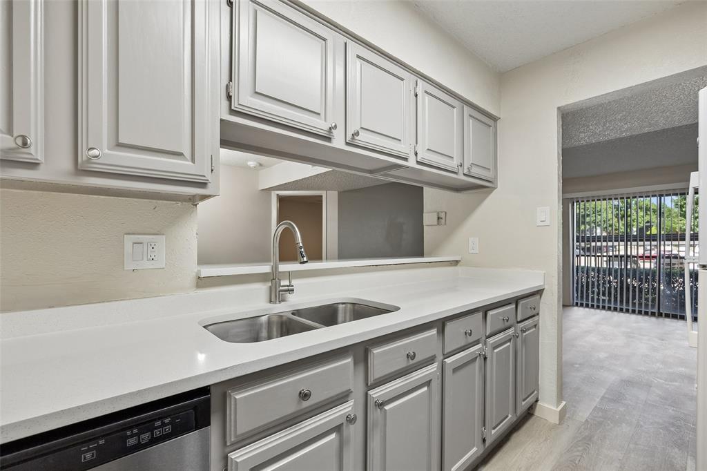 11480 Audelia Road, Unit 136 Dallas, TX 75243 - Photo 19 of 29 Kitchen featuring light gray cabinetry with silver hardware, white countertops, a stainless steel double basin sink, and a modern pull-down faucet