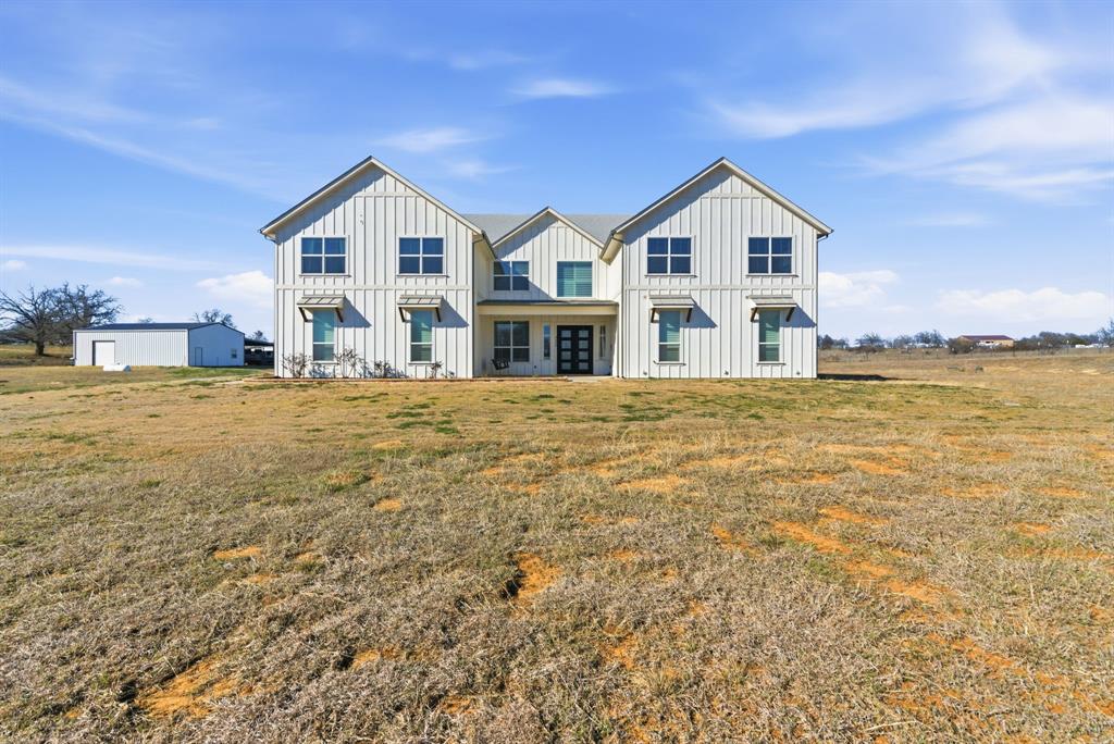 4600 B Old Brock Road Weatherford, TX 76087 - Photo 2 of 40 Back of house with board and batten siding and a lawn