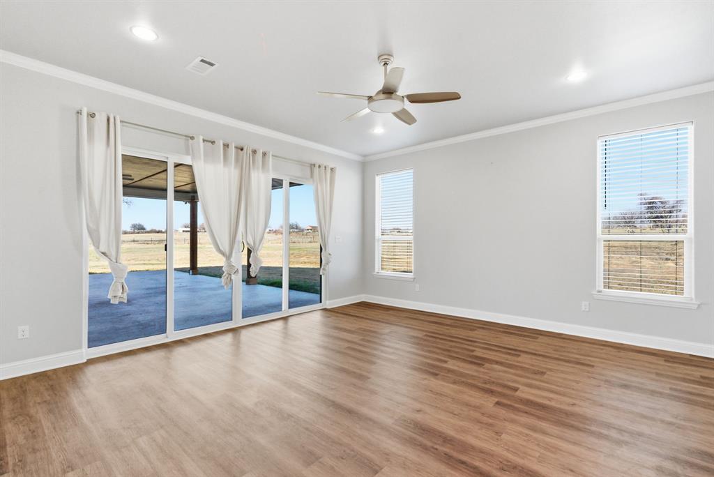 4600 B Old Brock Road Weatherford, TX 76087 - Photo 21 of 40 Unfurnished room featuring a ceiling fan, dark wood-style flooring, crown molding, and recessed lighting