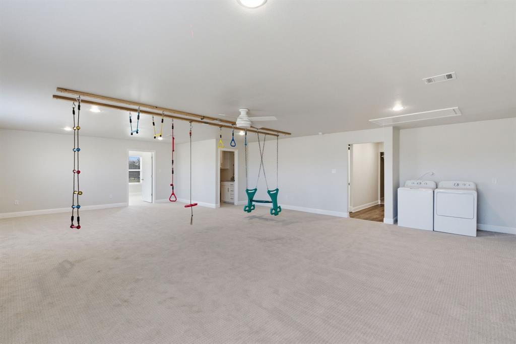 4600 B Old Brock Road Weatherford, TX 76087 - Photo 26 of 40 Basement featuring a ceiling fan, light colored carpet, and independent washer and dryer