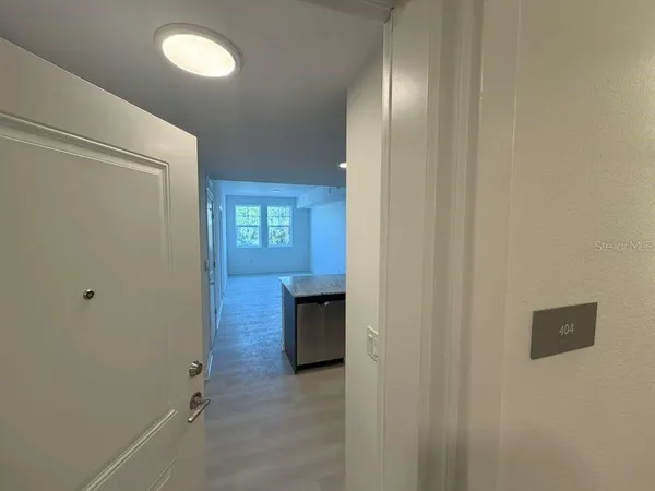 a view of a livingroom with wooden floor and window