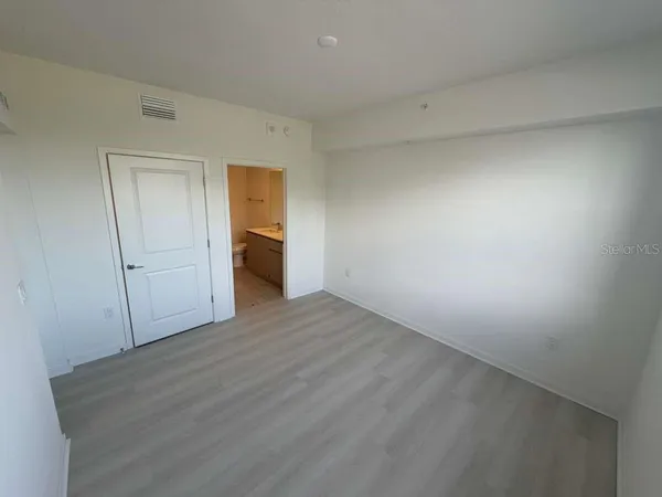 a view of an empty room and wooden floor