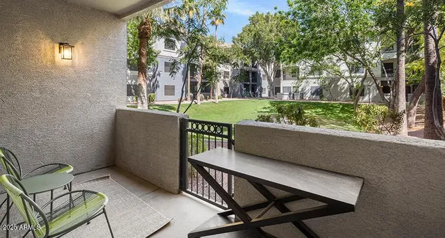 a view of a chairs and table in patio