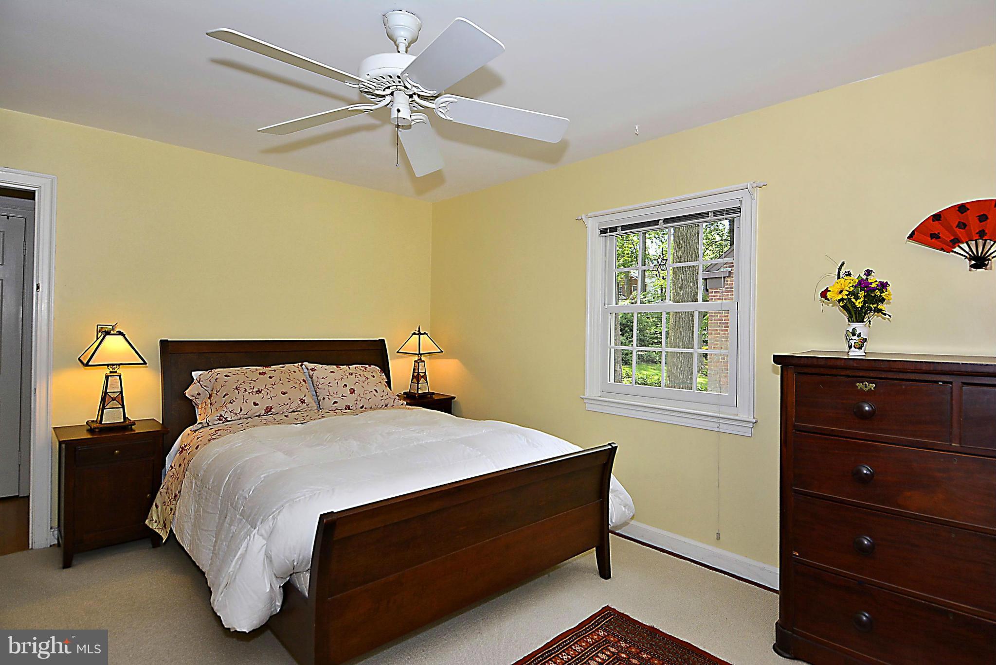 510 Ashford Road Silver Spring, MD 20910 - Photo 13 of 30 a bed sitting in a bedroom next to a window and a dresser
