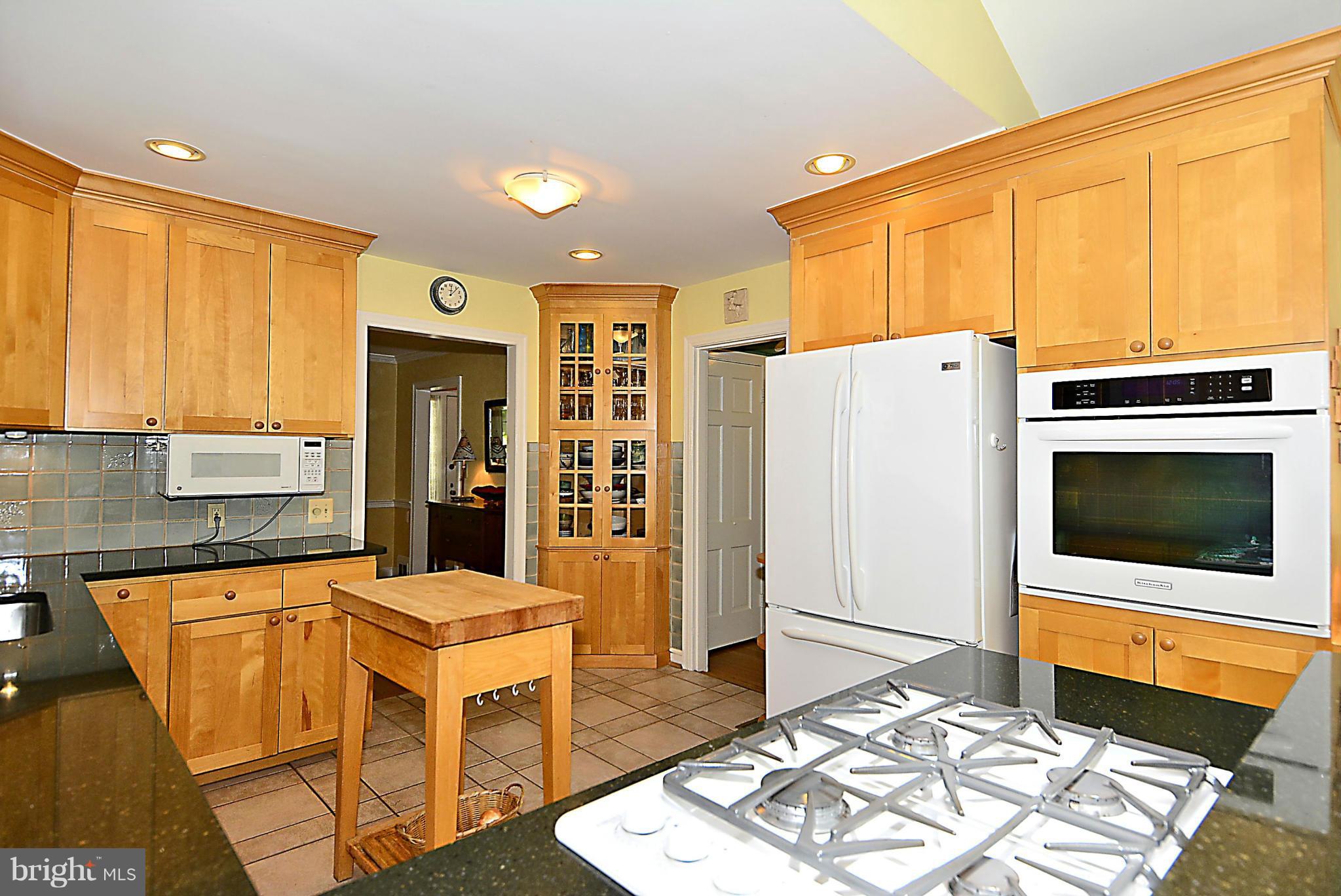 510 Ashford Road Silver Spring, MD 20910 - Photo 6 of 30 a open kitchen with stainless steel appliances granite countertop a refrigerator a stove top oven and a dining table with wooden floor