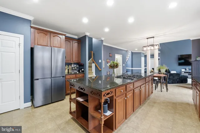 a kitchen with granite countertop sink stainless steel appliances and cabinets