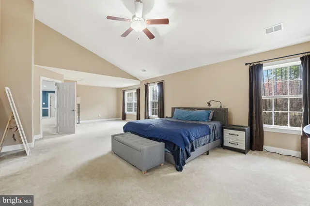a large bathroom with a glass door shower sink and a mirror
