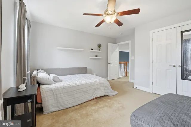 a bedroom with a bed and a large window