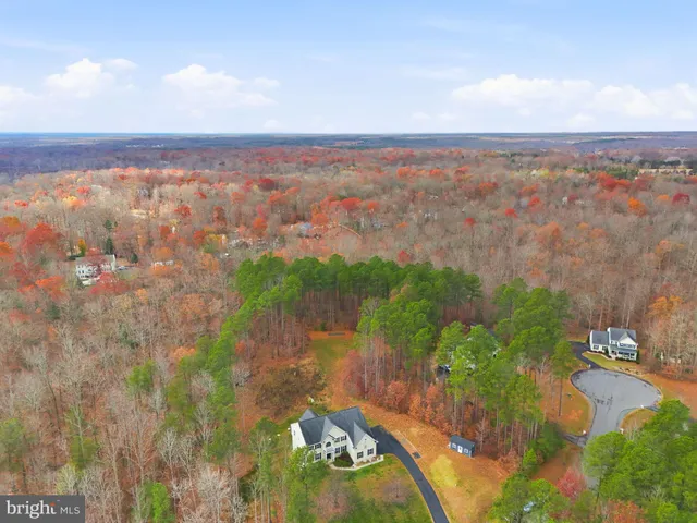 a view of a lake with houses in back