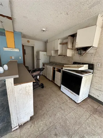 a kitchen that has a sink and a stove in it