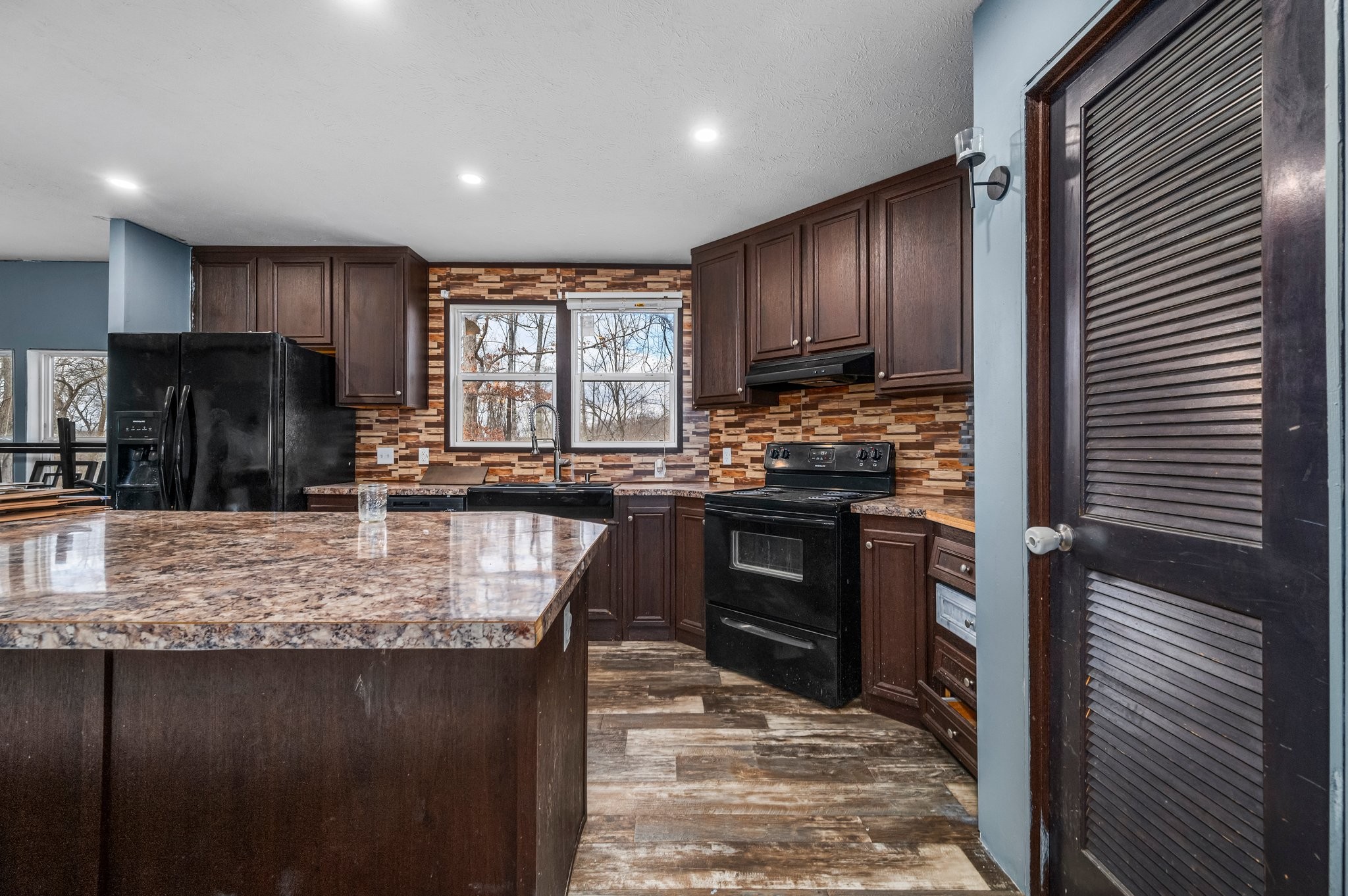6684 Wesley Ridge Road Lyles, TN 37098 - Photo 13 of 37 a kitchen with stainless steel appliances granite countertop wooden cabinets a refrigerator and a stove