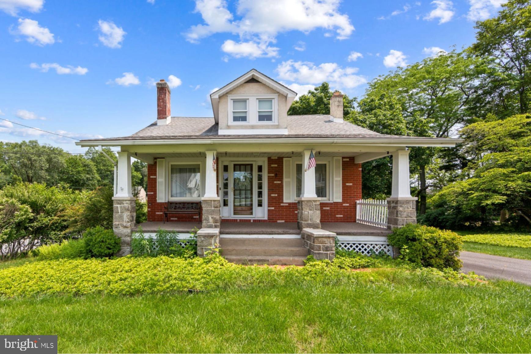 615 Convent Road Aston, PA 19014 - Photo 1 of 39 a front view of a house with a yard table and chairs